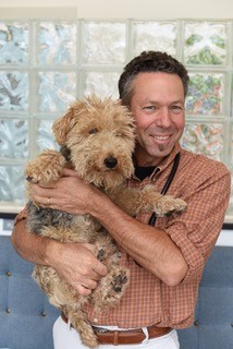 Alan holding a puppy.