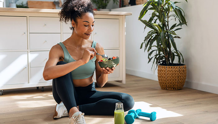 Athletic woman eating healthy