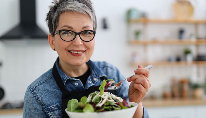 Senior woman eating salad