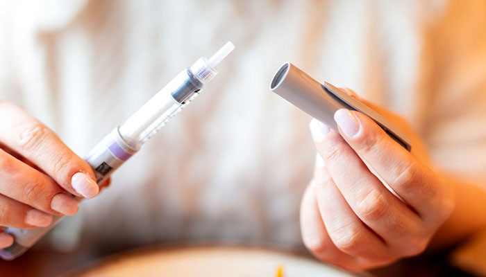 Closeup of hands holding a Semaglutide pen