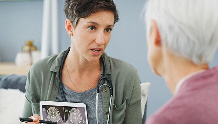 Female provider displaying medical scans on a tablet