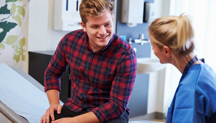 Young man in consultation with a physician