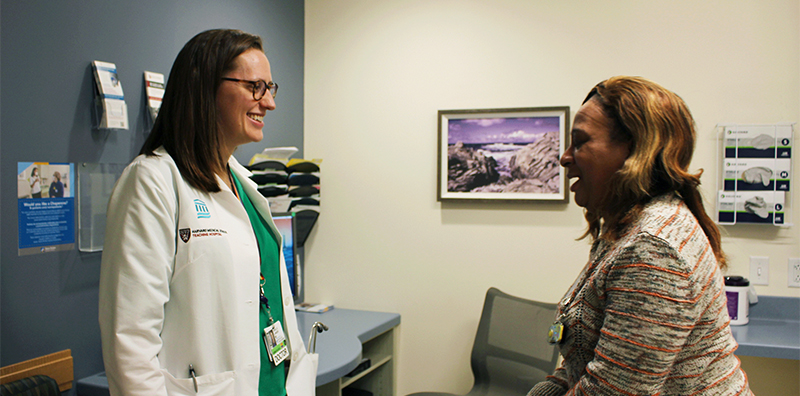 A medical provider meeting with a patient in an exam room