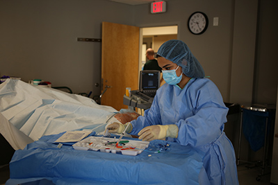 female medical provider demonstrating a procedure.