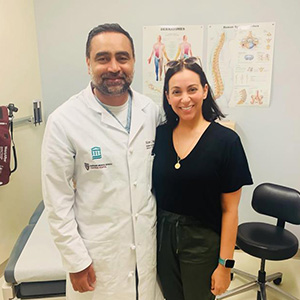 A patient smiling with their surgeon